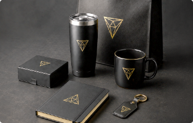 Promotional products including branded tumbler, mug, notebook, packaging, and keychain